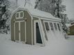 	There were a few steps missing since the last picture, but the next photo I took was this one after a snowstorm.  The shed is almost done.  Taia's painted it to match the house, and I've installed trim, made doors, and roofed it.

